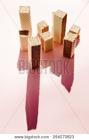 Creative Minimalist Picture Of Waffles Cookies Looks Like Skyscraper On Pink Background.