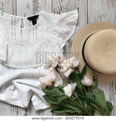 White Blouse With A Bouquet On A Wooden Background