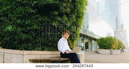 Statistician Working Outside With Laptop And Color Diagrams.