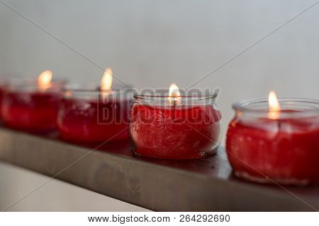 Four Red Candles In Glass Cups In Row In A Buddhist Temple, Chengdu, China