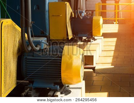 Two Large Electric Motors In The Production Workshop, Against The Background Of Sunlight, Electric M