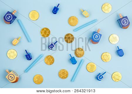 Blue Background With Multicolor Dreidels, Menora Candles And Chocolate Coins. Hanukkah And Judaic Ho
