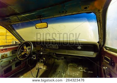 Inside View Of Old Broken Car Interior With Dusty Vehicle Dashboard, Back Mirror, Driving Steering W