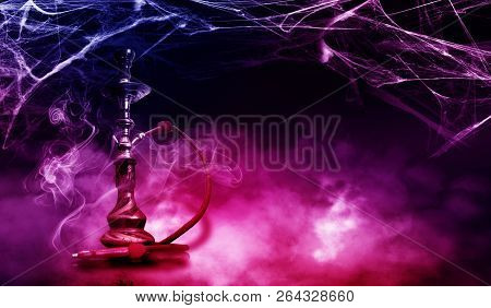 Hookah With Smoke And Neon Lights On A Dark Background In The Ba
