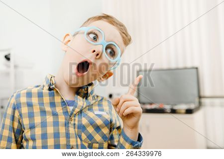 Child Boy Came Up With Idea, Finger Is Pointing, There Are Glasses For Sight In Front Of Eyes.