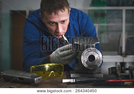 Man Worker Is Working With Iron Detail On Vise Grip On Blacksmith Table.