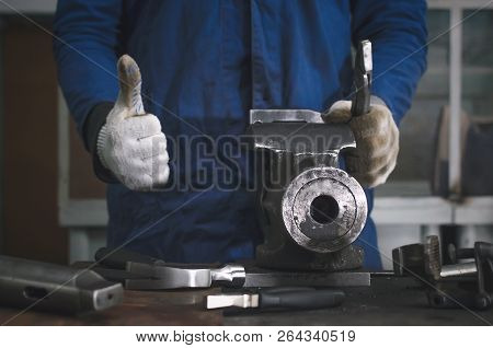 Man Worker Is Working With Iron Detail On Vise Grip On Blacksmith Table And Is Showing A Thumbs Up. 