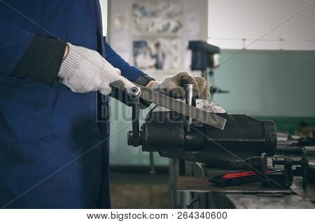 Man Worker Is Working With Iron Detail On Vise Grip On Blacksmith Table.