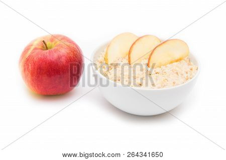 Oatmeal In White Bowl And Red Apple On White Background. Isolated On White. Healthy Food