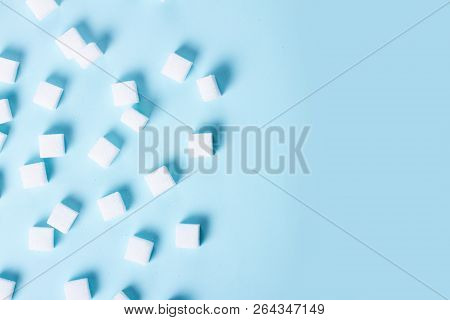 Sugar Cubes On Blue Background, Flat Lay Scene With Copy Space