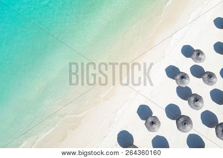 Aerial View Of Amazing Tropical White Sandy Beach With Palm Leaves Umbrellas And Turquoise Sea.