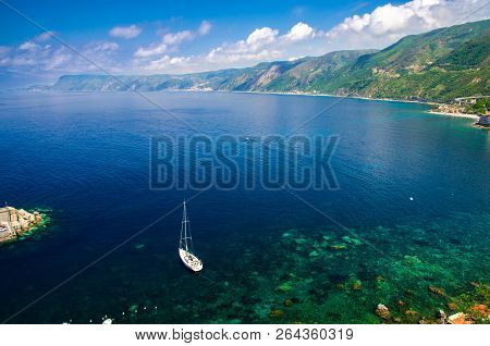 Aerial Top View Of White Yacht Ship Boat In Blue Lagoon Near Small Fishing Village Chianalea Di Scil