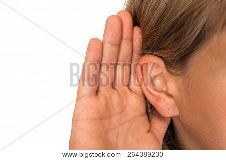 Woman Is Listening With Her Hand On An Ear - Hearing Loss Concept