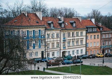 Beautiful Street With Traditional Colorful Houses In Warsaw In Poland. Near The Houses Are Parked Ca
