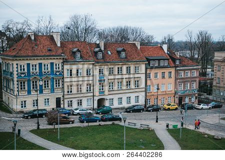 Beautiful Street With Traditional Colorful Houses In Warsaw In Poland. Near The Houses Are Parked Ca