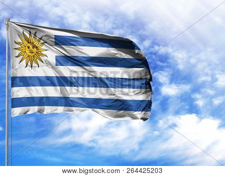 National Flag Of Uruguay On A Flagpole In Front Of Blue Sky