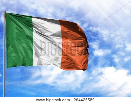 National Flag Of Ireland On A Flagpole In Front Of Blue Sky