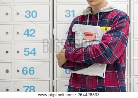 Happy Young Teenager Holding Recieved Mail Package With New Clothes Inside The Post Office