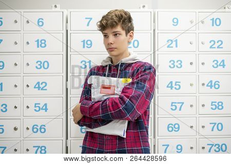 Happy Young Teenager Holding Recieved Mail Package With New Clothes Inside The Post Office