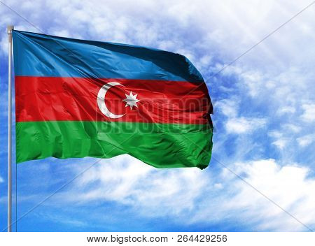 National Flag Of Azerbaijan On A Flagpole In Front Of Blue Sky