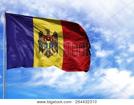 National Flag Of Moldova On A Flagpole In Front Of Blue Sky