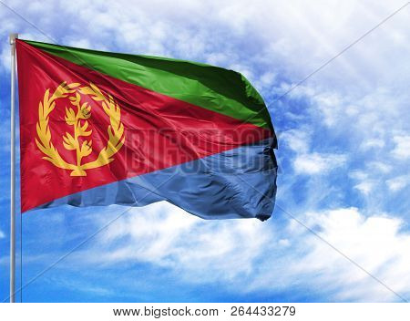 National Flag Of Eritrea On A Flagpole In Front Of Blue Sky