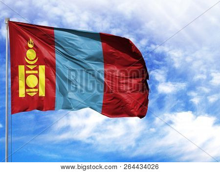 National Flag Of Mongolia On A Flagpole In Front Of Blue Sky