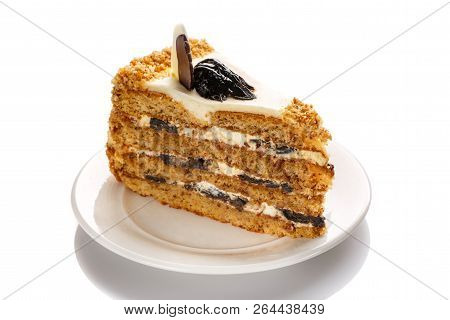 A Piece Of Cake With Honey And Prunes, Highlighted With A White Background