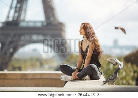 Happy Travel Woman Near The Eiffel Tower, Paris. Travel Tourist Girl On Vacation Resting Happy Outdo