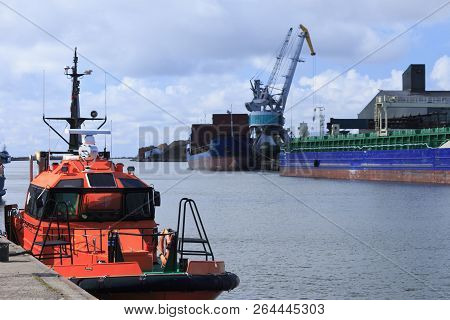 Rescue Vessel In Front Of The Port. Transshipment Of Goods In Port Of Liepaja In Latvia. Liepaja Is 