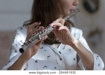 Girl Plays On Flute. Flute In Hands Of Girl During The Concert. Professional Musician Playing On Flu
