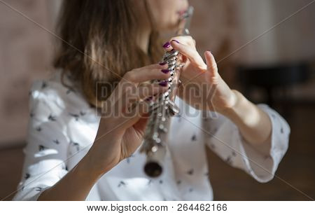 Girl Plays On Flute. Flute In Hands Of Girl During The Concert. Professional Musician Playing On Flu