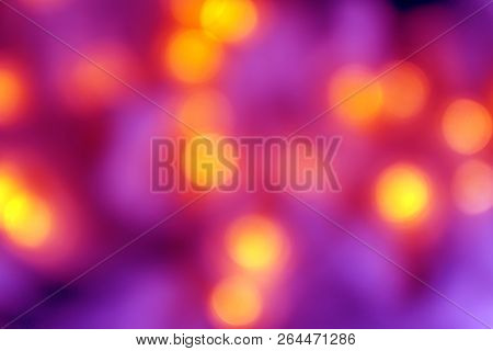Background Of Blurry Pink-purple-lilac Lights Of The Christmas-tree Garland On The Dark. Copy Space