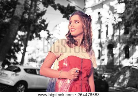 Appealing Dark-haired Woman Wearing Nice Accessories Looking On Building
