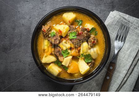 Goulash With Meat And Vegetables On Black Background. Beef Stew With Vegetables. European Cuisine. T