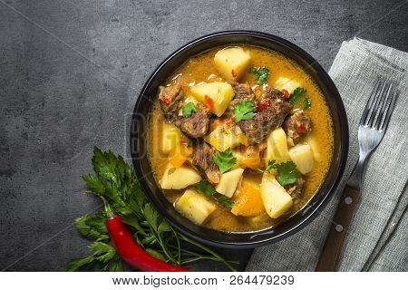 Goulash With Meat And Vegetables On Black Background. Beef Stew With Vegetables. European Cuisine. T