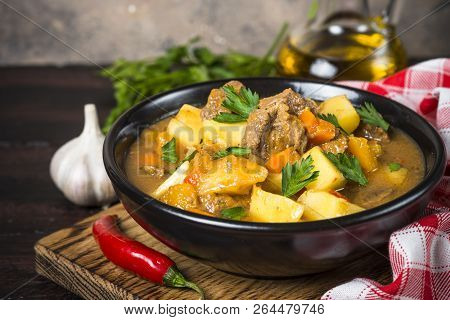 Goulash With Meat And Vegetables In Black Bowl. Beef Stew With Vegetables. European Cuisine.