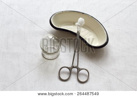 Retro. Glass Medical Can, Metallic Forceps With A Cotton Swab And Metal Kidney Shaped Bath For Medic