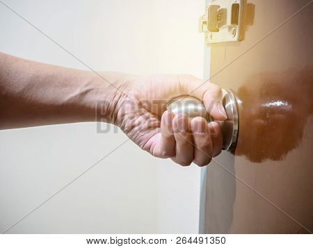 Close Up Of Hand Holding A Door Knob, Opening Or Closing The Door.