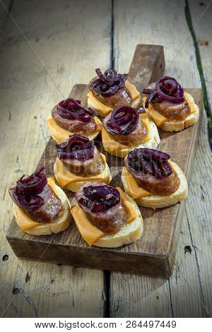 Croutons Of Bread With Cheese Sausage And Caramelized Onion