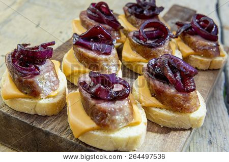 Croutons Of Bread With Cheese Sausage And Caramelized Onion