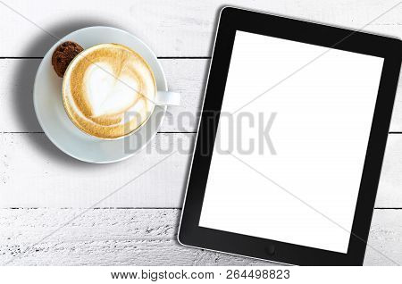 Directly Above Shot Of Cup Of Cappuccino And Tablet Computer On Rustic White Wooden Table