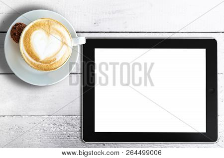 Directly Above Shot Of Cup Of Cappuccino And Tablet Computer On Rustic White Wooden Table
