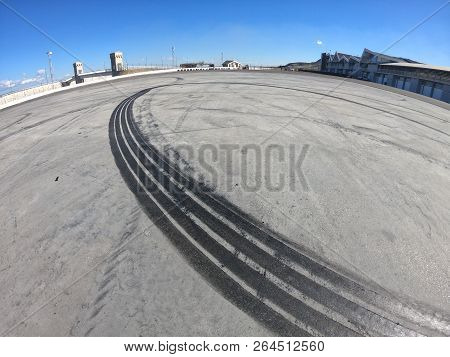 Wheel Marks On Concrete And On The Pavement After Drifting On A Sunny Day
