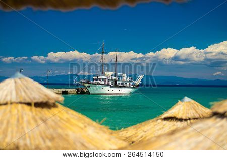 View Of Ship Boat On Blue Paradise Water Of Toroneos Kolpos Gulf, Blue Sky, White Clouds Over Sithon
