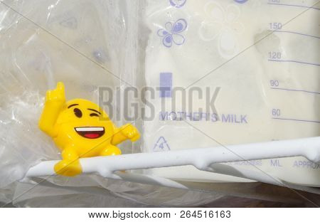 Lot Of Frozzen Breast Milk In Storage Bags Stored In The Freezer And Baby Bottle With Fresh Expresed