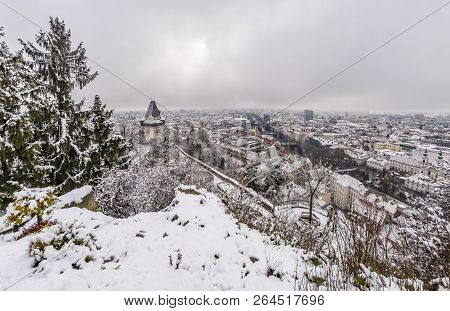 Landmark Uhrturm On Hill Schlossberg In Graz On A Snowy Winterday