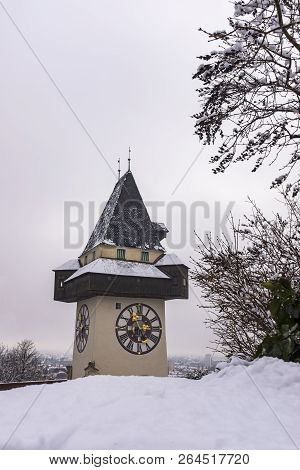 Landmark Uhrturm On Hill Schlossberg In Graz On A Snowy Winterday