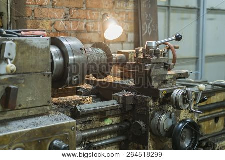 Old Machinery In A Factory From The Mid-20th C. Working Machine-tool. Old Lathe. Old Rotary Lathe Ma