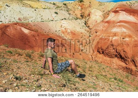 Relaxing man in Valley of Mars landscapes in the Altai Mountains, Kyzyl Chin, Siberia, Russia